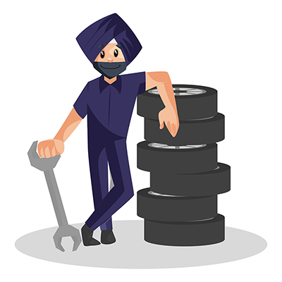 Punjabi mechanic is standing with wheels and wrench