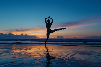 Silhouette image of girl doing yoga in sunset on beach