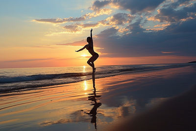 Silhouette of girl doing yoga in sunset on beach