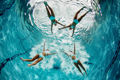 Image of swimmers gracefully floating on water