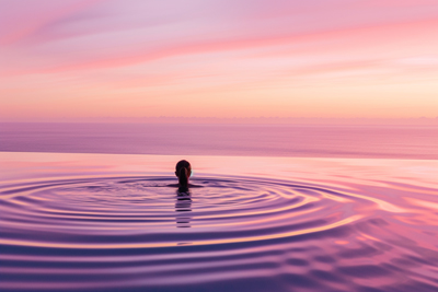 Picture of a swimmer in tranquil pool at sunrise